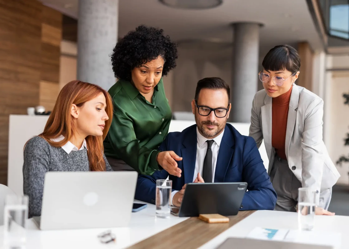 Team collaborating around a tablet