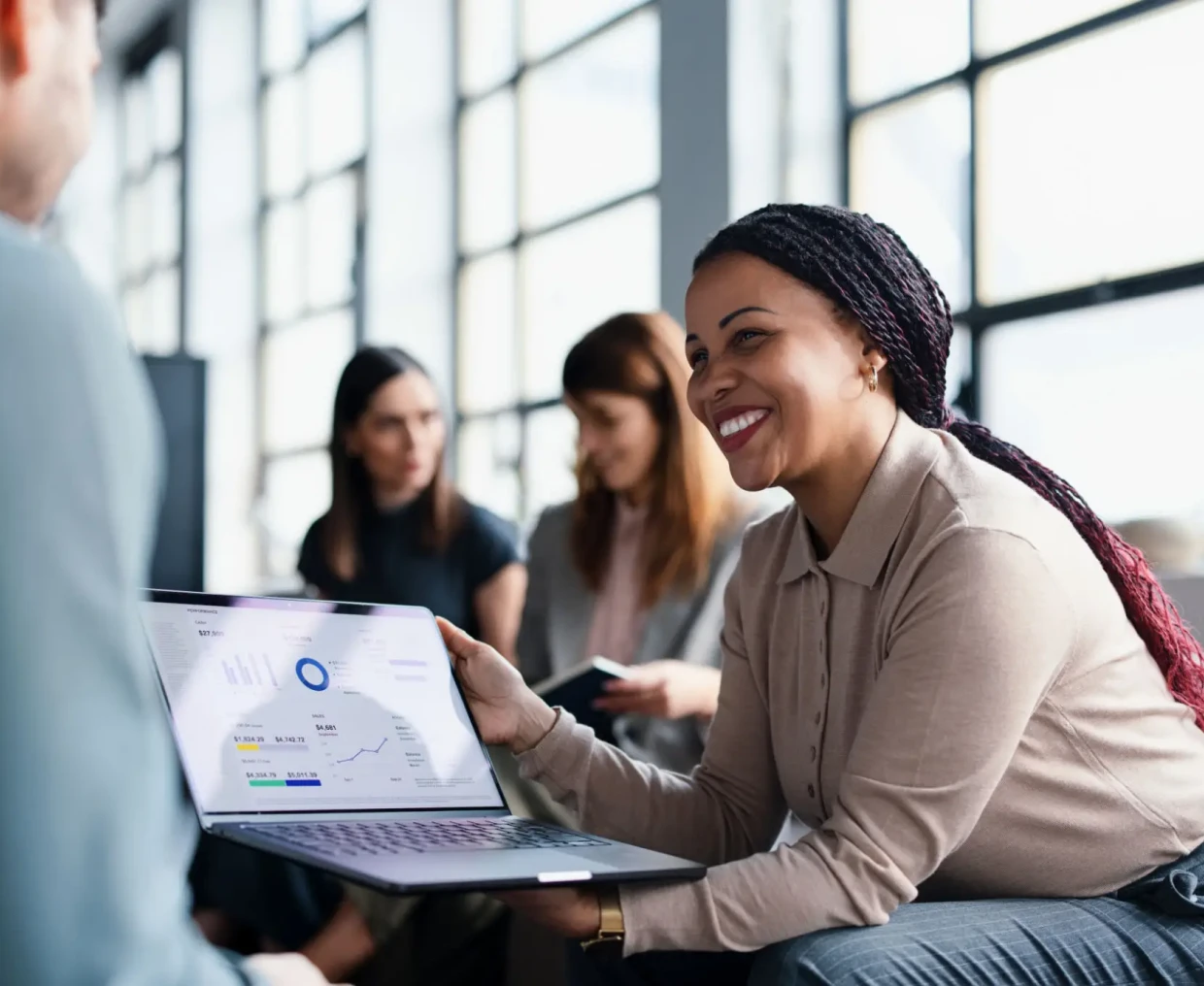 Woman presenting data on a laptop