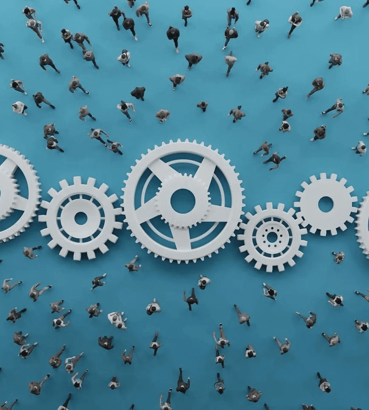 Miniature people working around large interlocking gears on a blue surface.